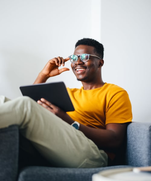 Resident using the online portal on his tablet at Lakeside Terraces in Sterling Heights, Michigan