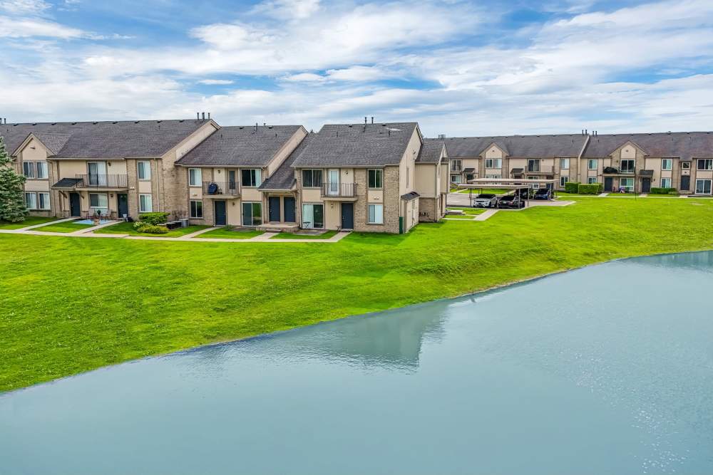 View of the apartment buildings from across the lake at Lakeside Terraces in Sterling Heights, Michigan